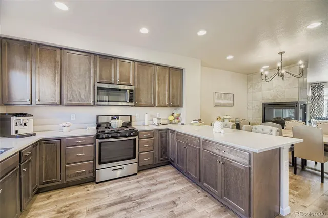 a kitchen with a sink stove and microwave