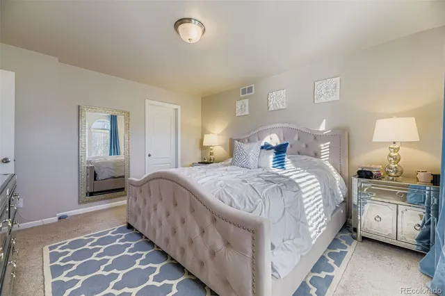 a bedroom with a bed and a lamp