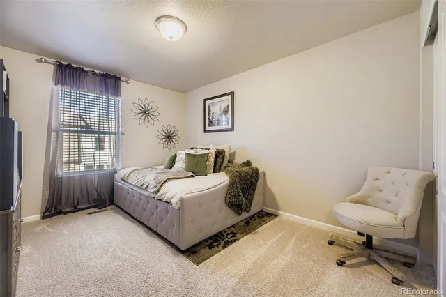 a bed room with a bed and a chair