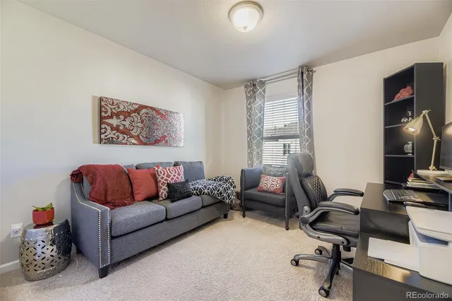 a living room with furniture and a air conditioner vent