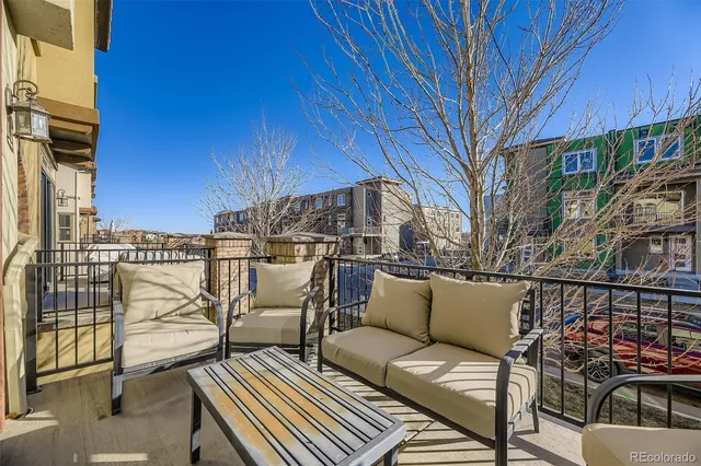 a balcony with table and chairs
