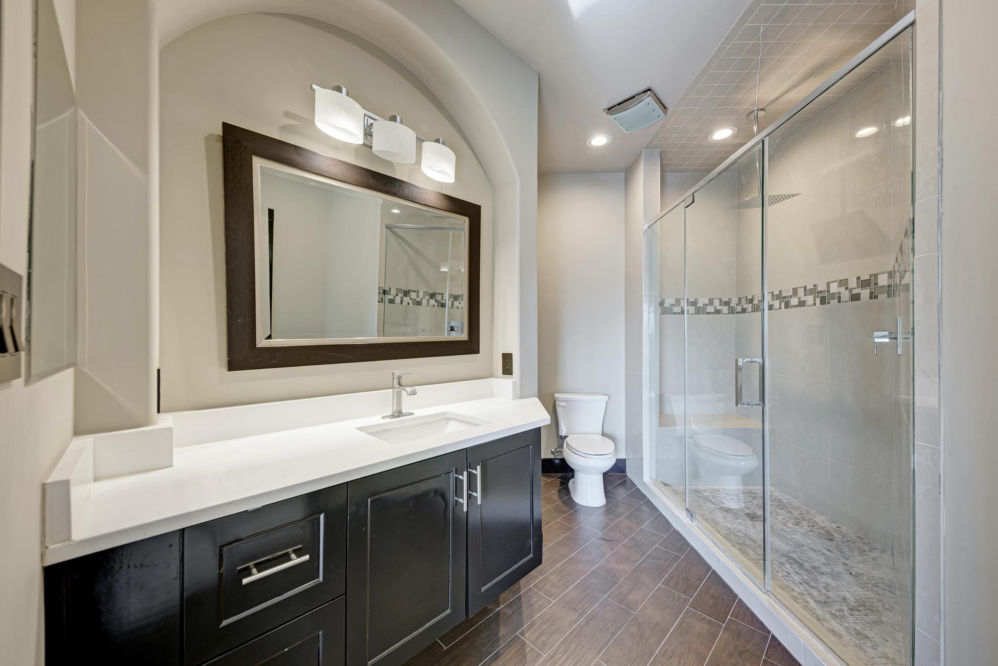 104 Spring Valley Street Hutto, TX 78634 - Photo 25 of 40 Bathroom featuring vanity, a stall shower, recessed lighting, and wood tiled floors