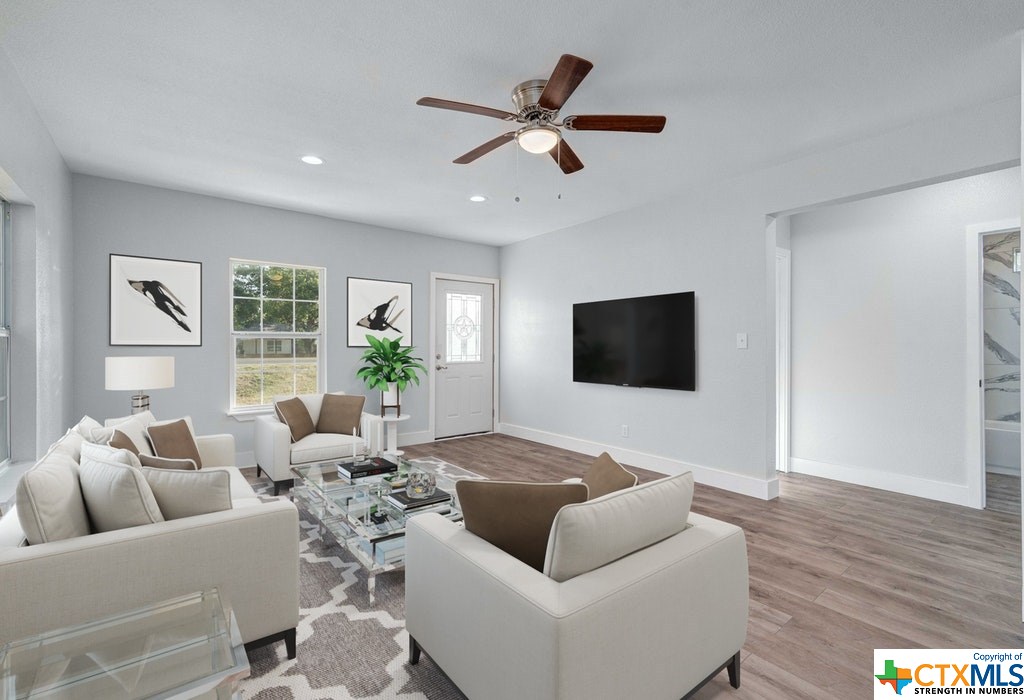 a living room with furniture and a flat screen tv