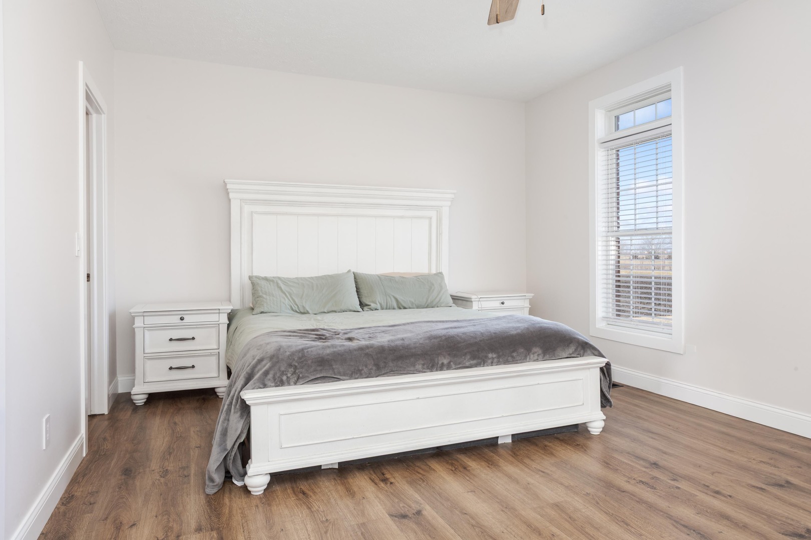 1651 North 2800 East Road Le Roy, IL 61752 - Photo 26 of 90 a spacious bedroom with a bed and wooden floor