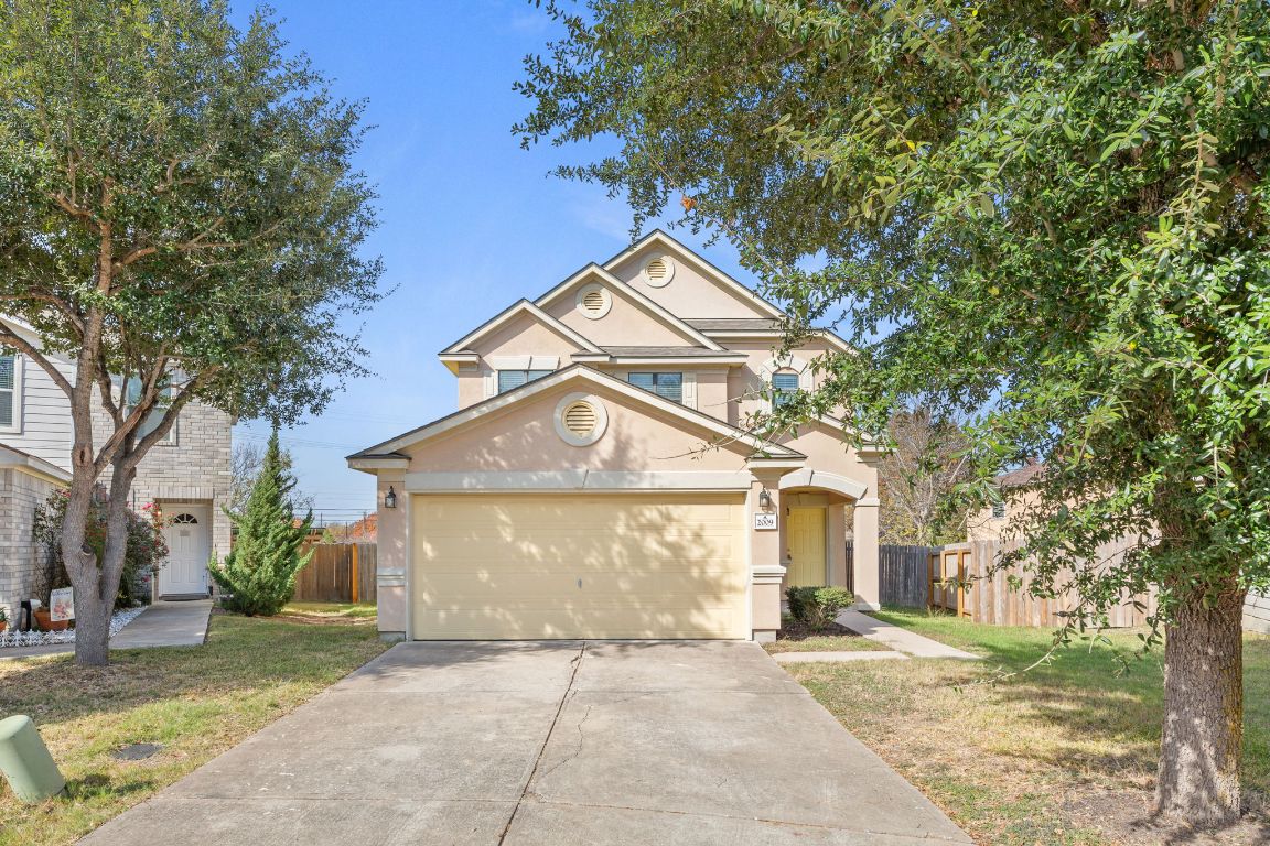 a front view of a house with a yard and garage