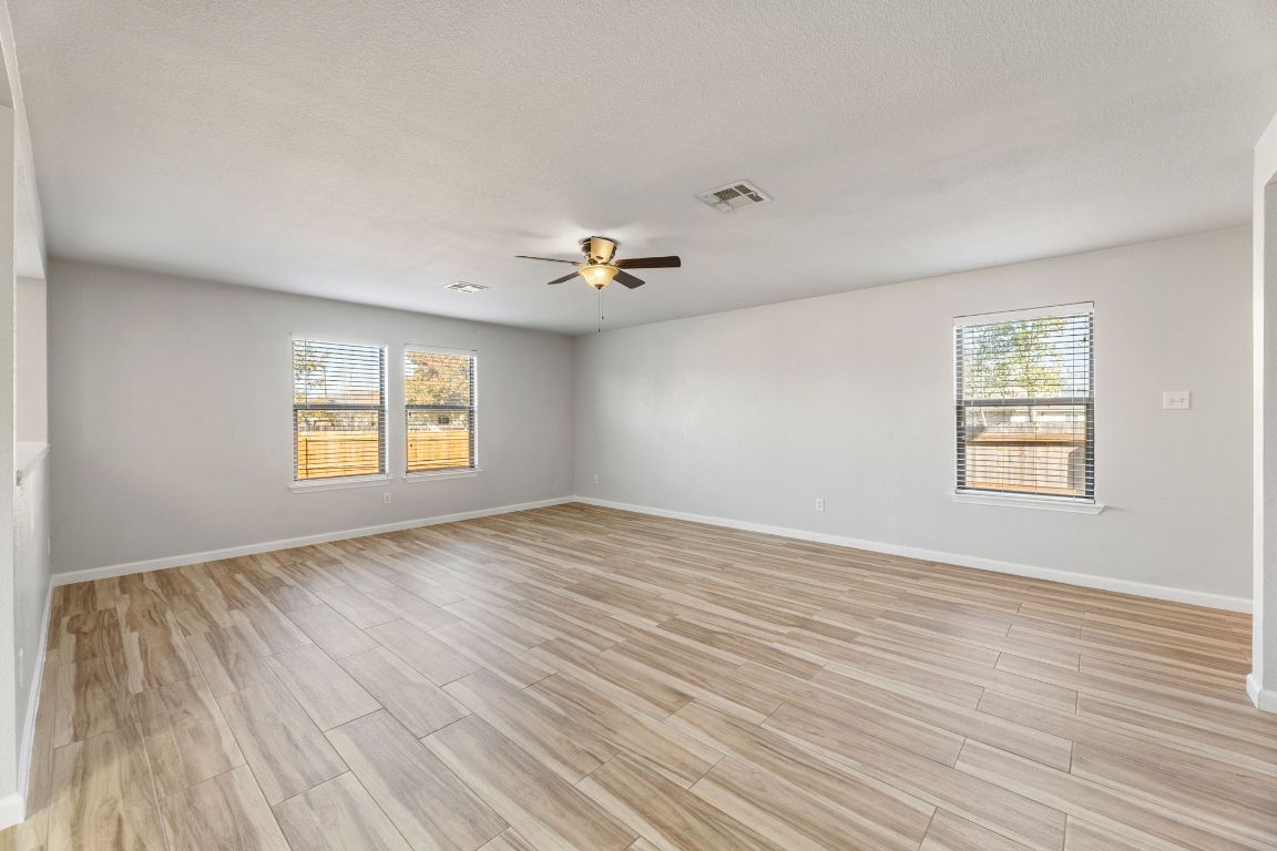 2009 Perkins Place Georgetown, TX 78626 - Photo 11 of 36 wooden floor in an empty room with a window