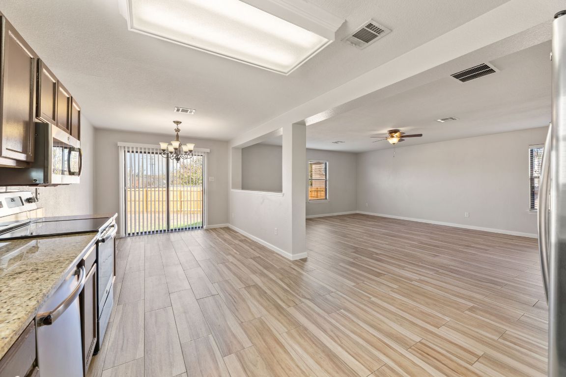 2009 Perkins Place Georgetown, TX 78626 - Photo 16 of 36 an empty room with wooden floor and windows