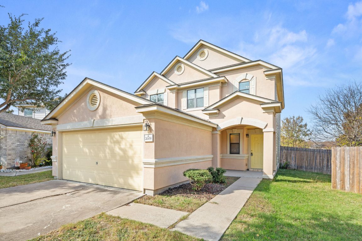 2009 Perkins Place Georgetown, TX 78626 - Photo 3 of 36 a view of a white house with a small yard and large tree