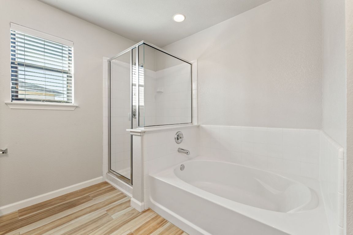 2009 Perkins Place Georgetown, TX 78626 - Photo 30 of 36 a bathroom with a bathtub and a shower