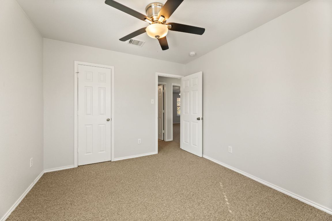 2009 Perkins Place Georgetown, TX 78626 - Photo 32 of 36 an empty room with closet and a chandelier fan