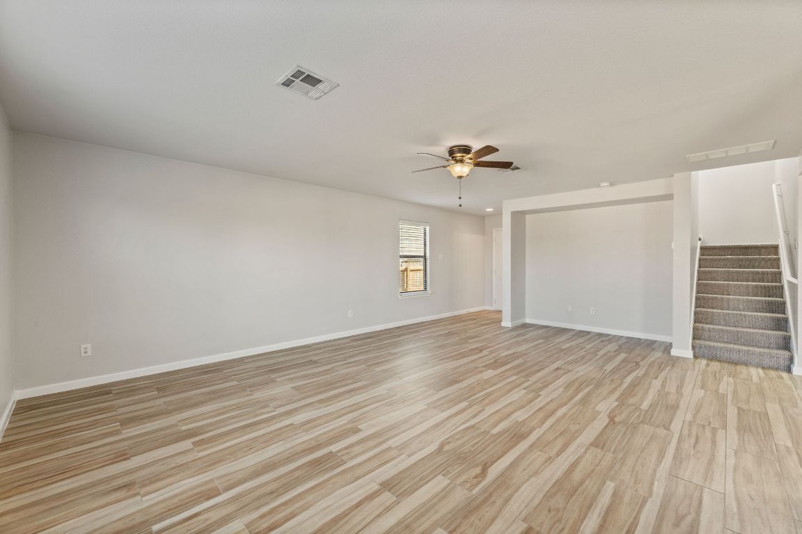2009 Perkins Place Georgetown, TX 78626 - Photo 10 of 36 a view of empty room with wooden floor and fan