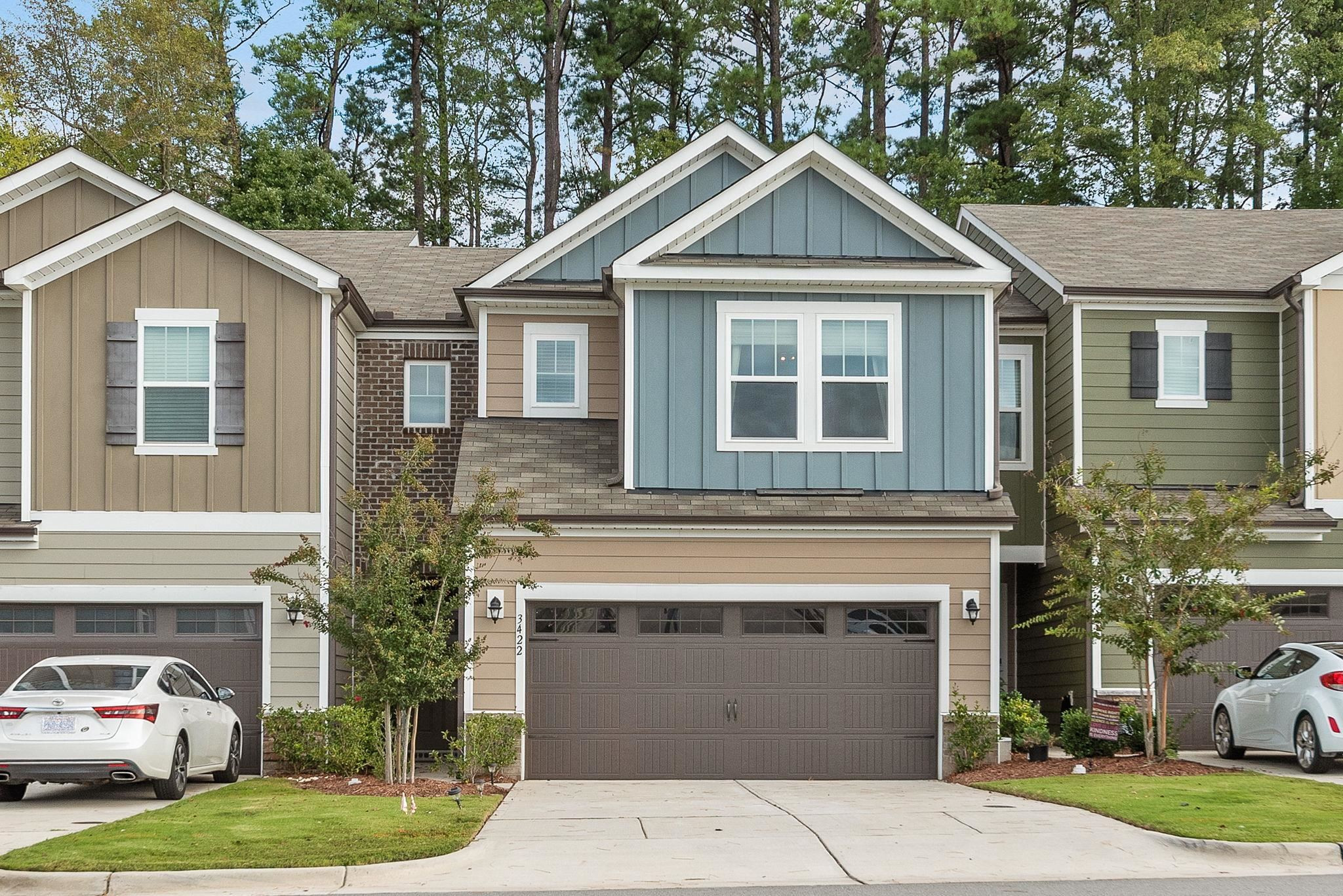 a front view of a house with a yard and garage
