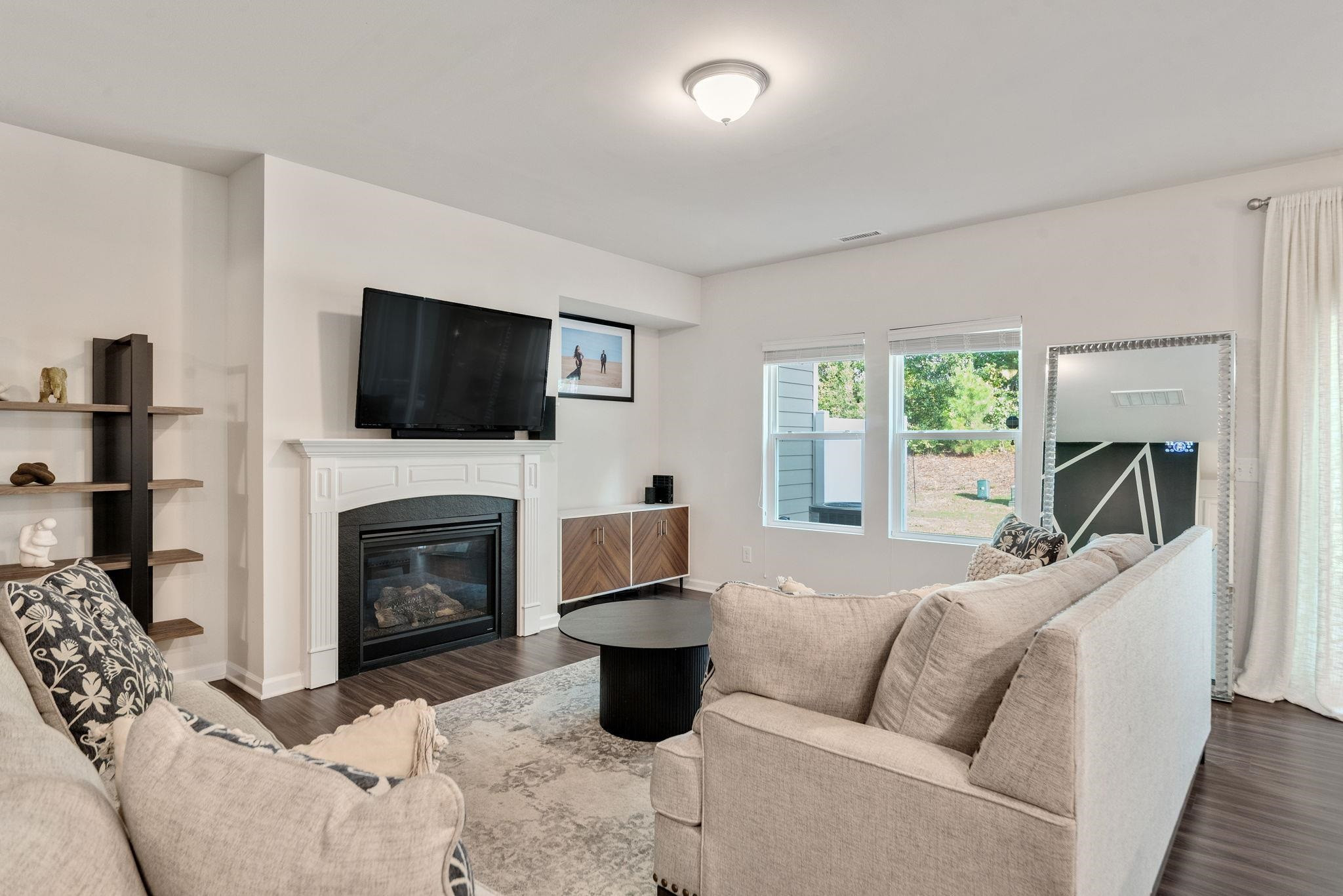 3422 Dropseed Drive Apex, NC 27502 - Photo 12 of 40 a living room with furniture a flat screen tv and a fireplace