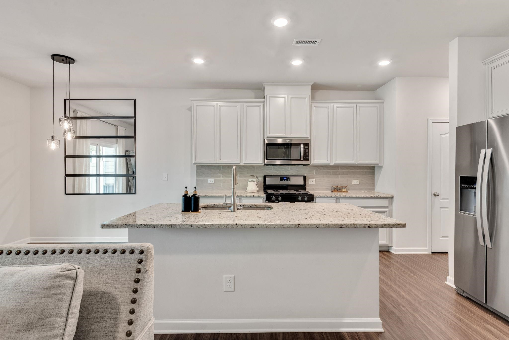 3422 Dropseed Drive Apex, NC 27502 - Photo 13 of 40 a kitchen with stainless steel appliances granite countertop a refrigerator sink and cabinets