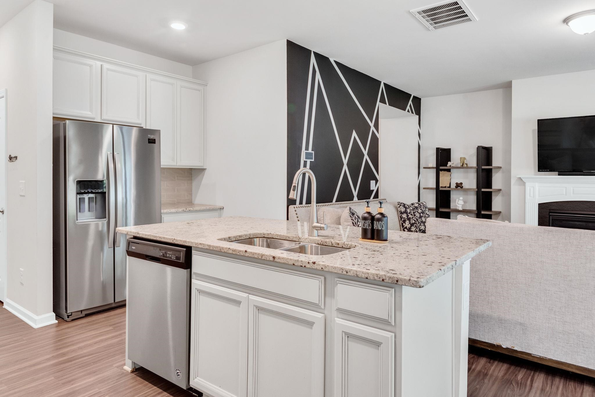 3422 Dropseed Drive Apex, NC 27502 - Photo 15 of 40 a kitchen with stainless steel appliances granite countertop a sink and a refrigerator