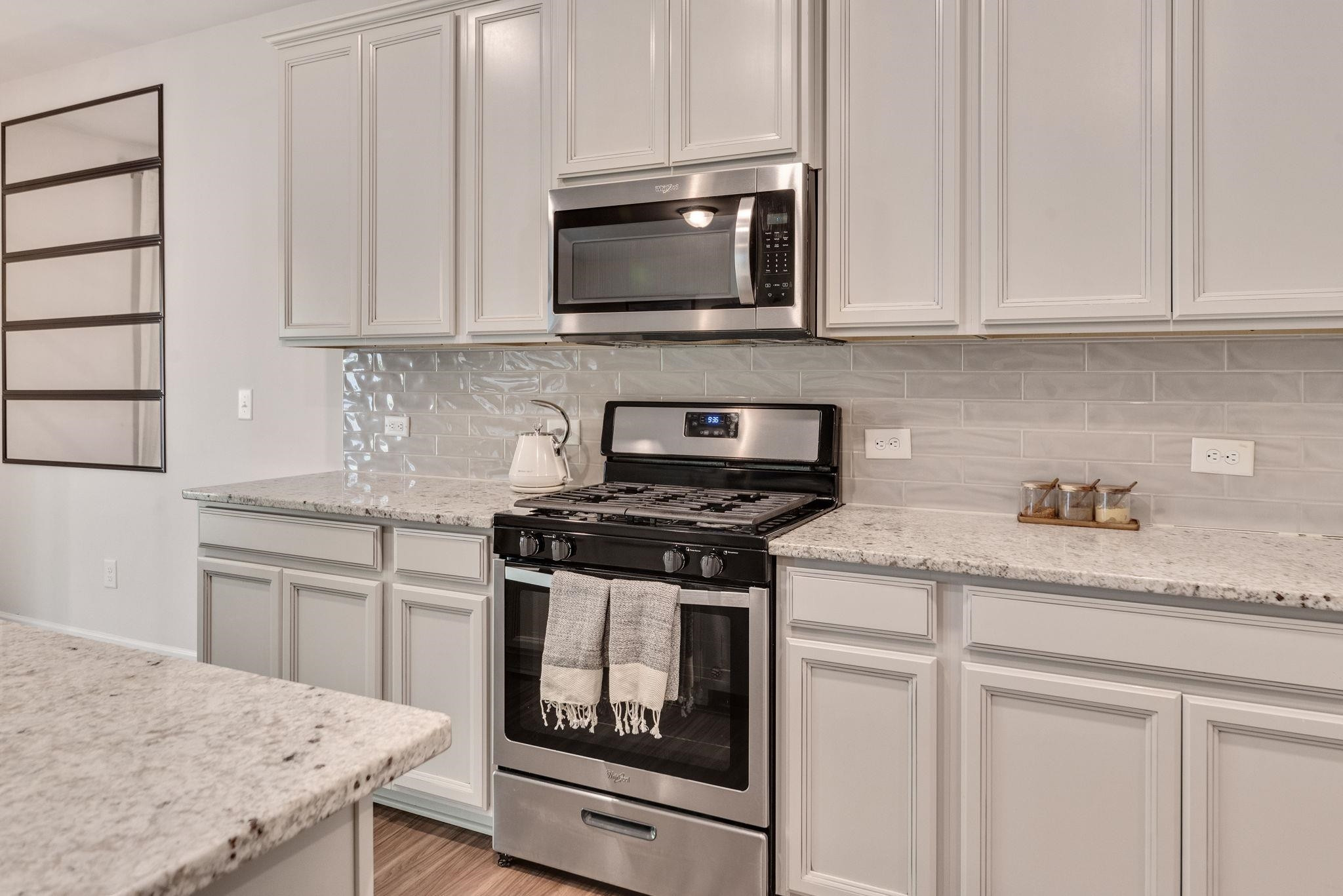 3422 Dropseed Drive Apex, NC 27502 - Photo 16 of 40 a kitchen with granite countertop white cabinets stainless steel appliances and sink