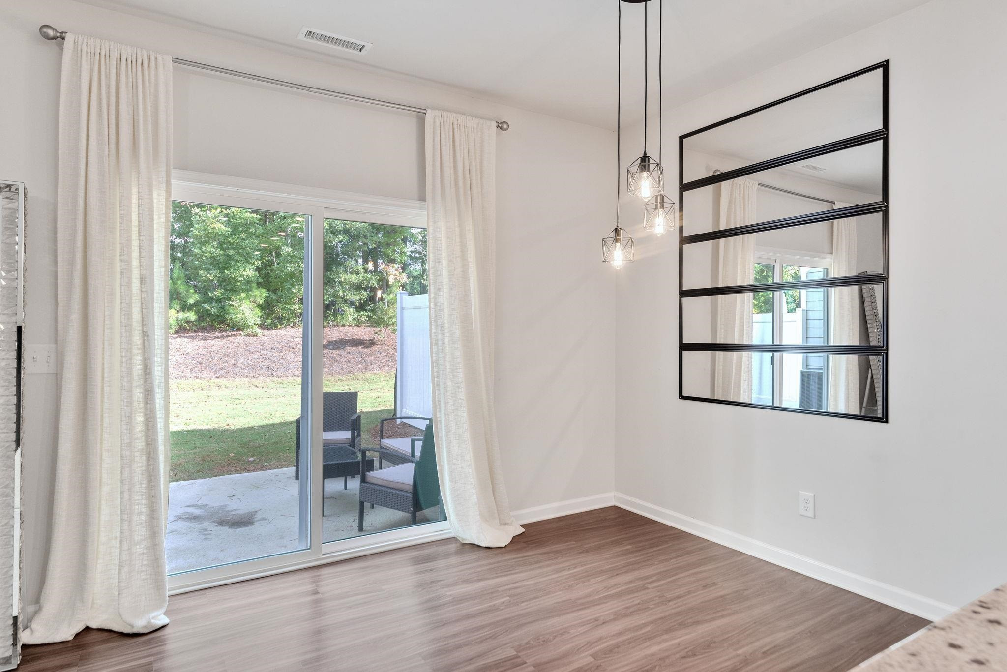 3422 Dropseed Drive Apex, NC 27502 - Photo 19 of 40 a view of room with window and hardwood floor