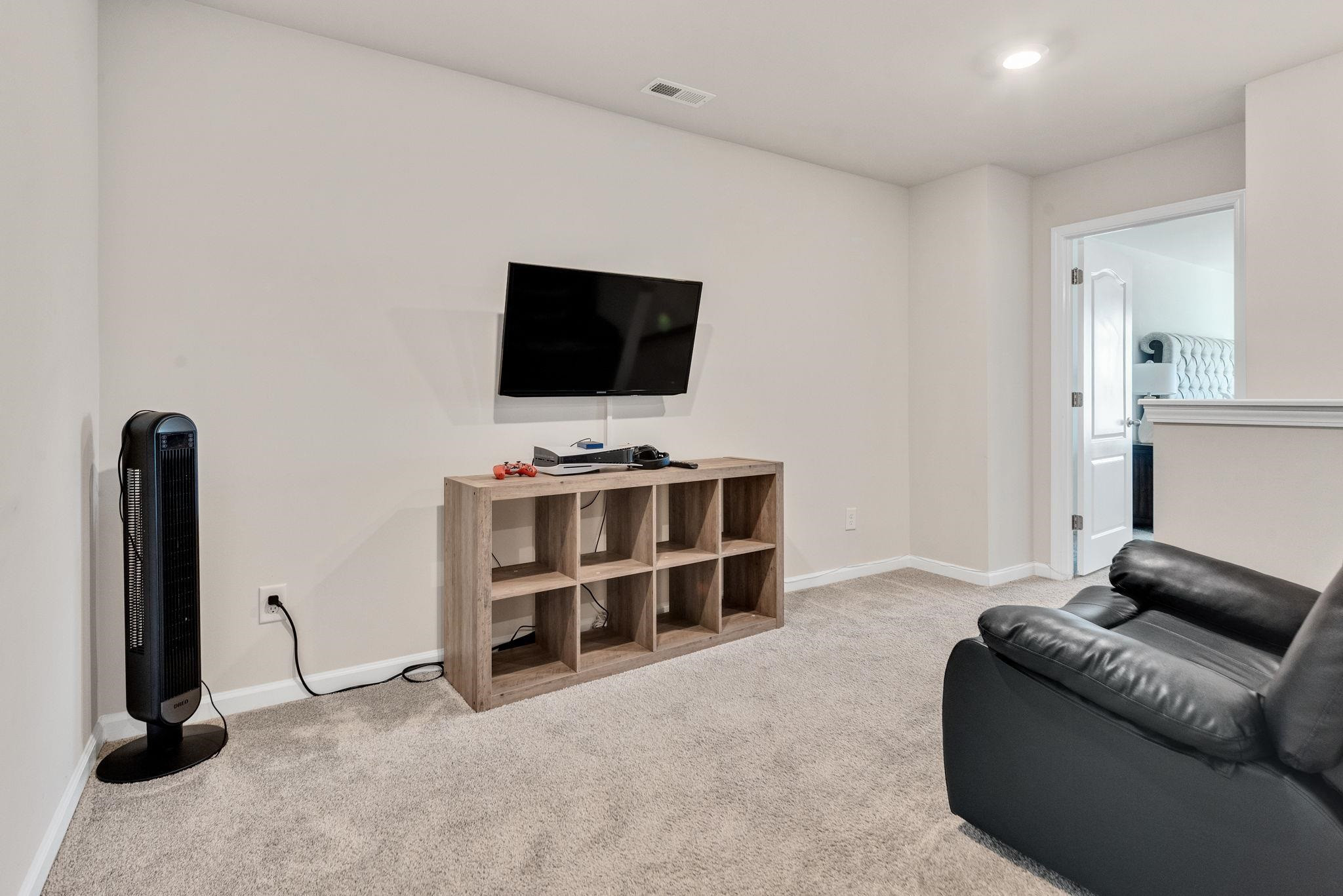 3422 Dropseed Drive Apex, NC 27502 - Photo 21 of 40 a living room with furniture and a flat screen tv