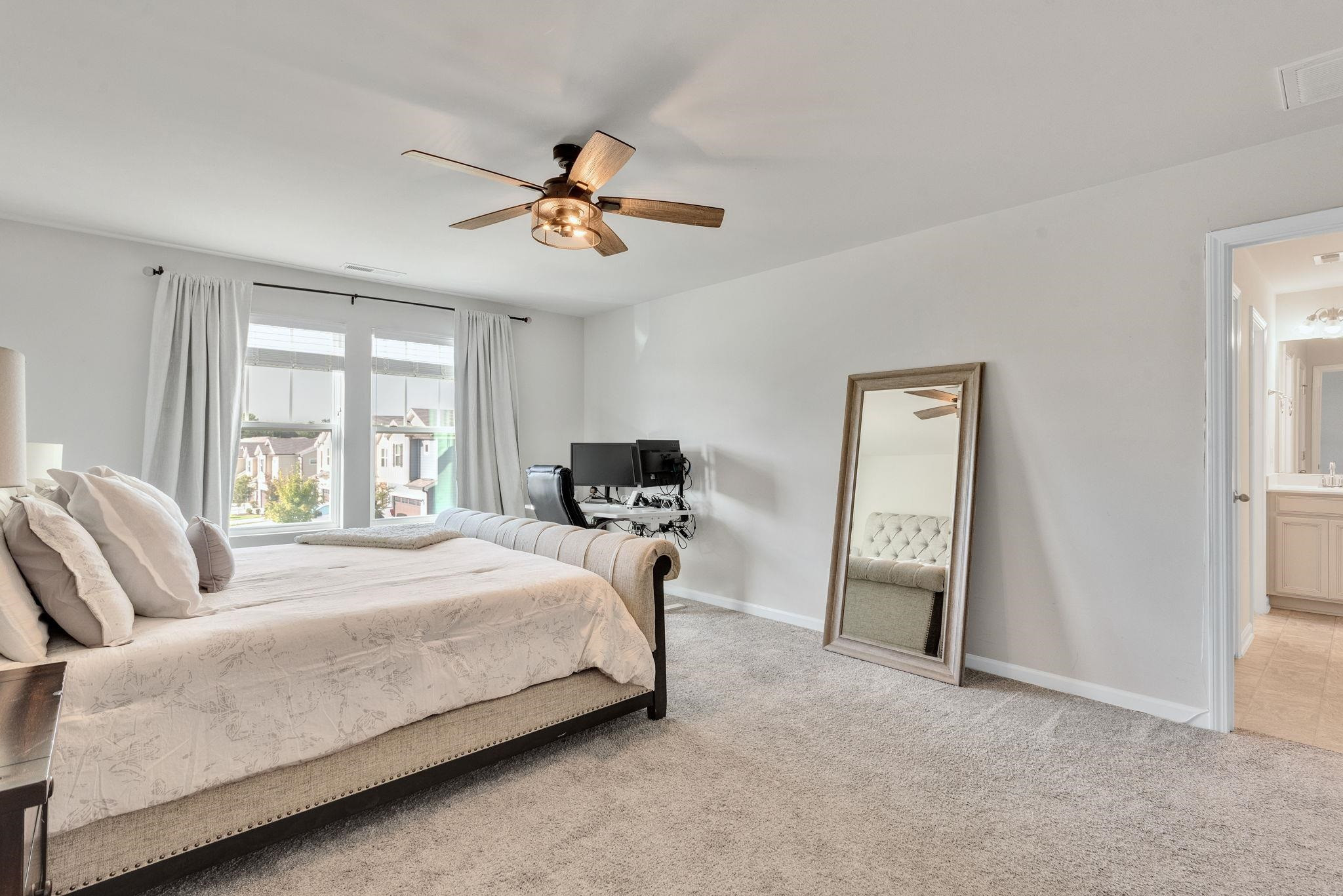 3422 Dropseed Drive Apex, NC 27502 - Photo 22 of 40 a bedroom with a bed and a chandelier