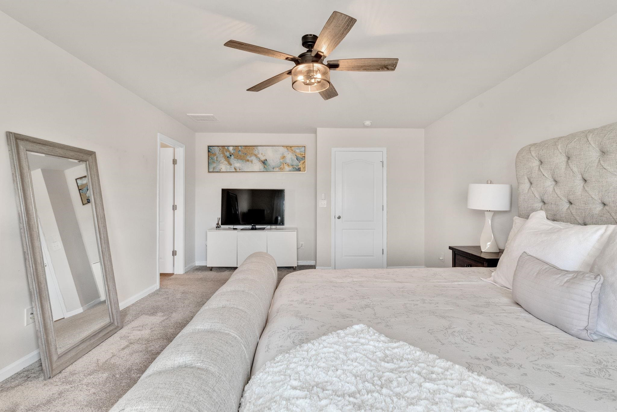 3422 Dropseed Drive Apex, NC 27502 - Photo 23 of 40 a bedroom with a bed and a flat screen tv