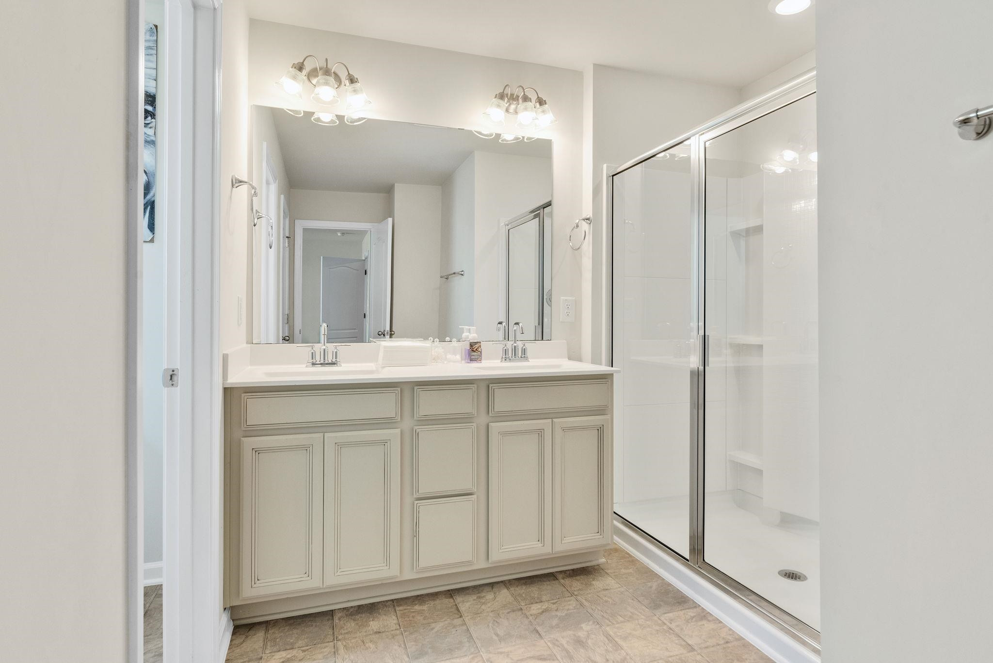 3422 Dropseed Drive Apex, NC 27502 - Photo 24 of 40 a bathroom with a double vanity sink mirror and shower