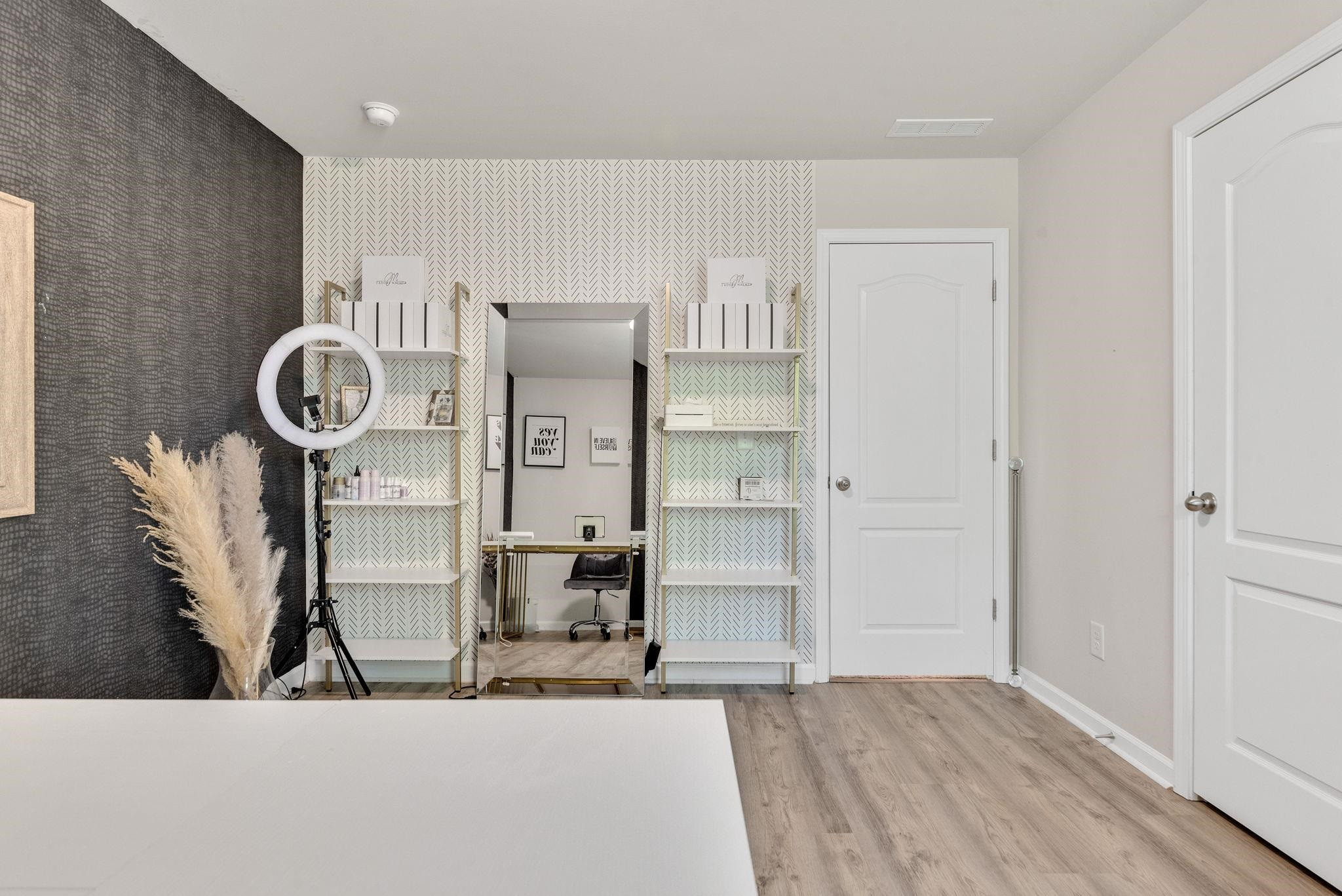 3422 Dropseed Drive Apex, NC 27502 - Photo 26 of 40 a living room with kitchen island furniture a clock and wooden floor