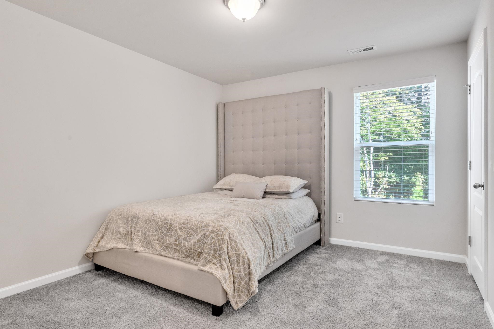 3422 Dropseed Drive Apex, NC 27502 - Photo 28 of 40 a bedroom with a bed and window