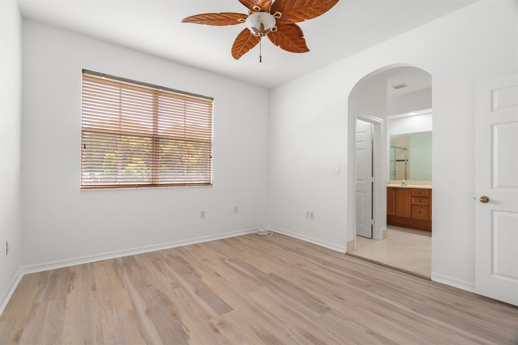 3210 Merrick Terrace, Unit 1503 Margate, FL 33063 - Photo 12 of 24 wooden floor in an empty room with a window