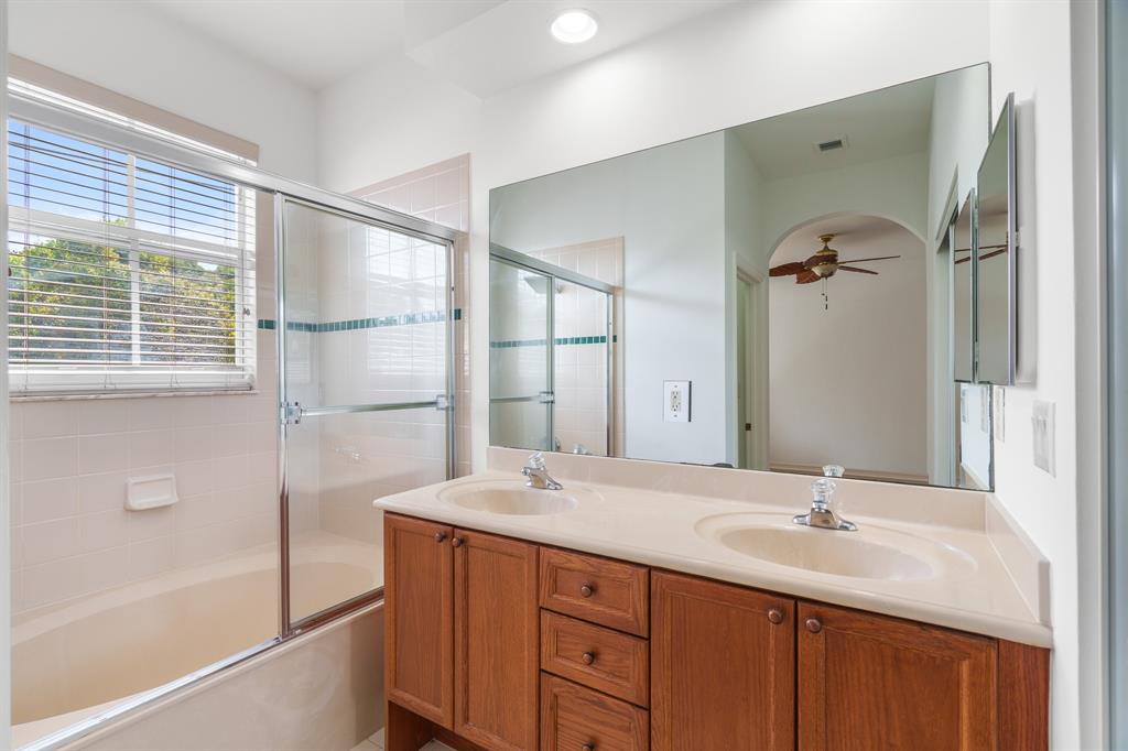 3210 Merrick Terrace, Unit 1503 Margate, FL 33063 - Photo 15 of 24 a bathroom with a double vanity sink a mirror and a bathtub