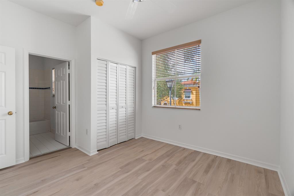3210 Merrick Terrace, Unit 1503 Margate, FL 33063 - Photo 21 of 24 an empty room with wooden floor and windows