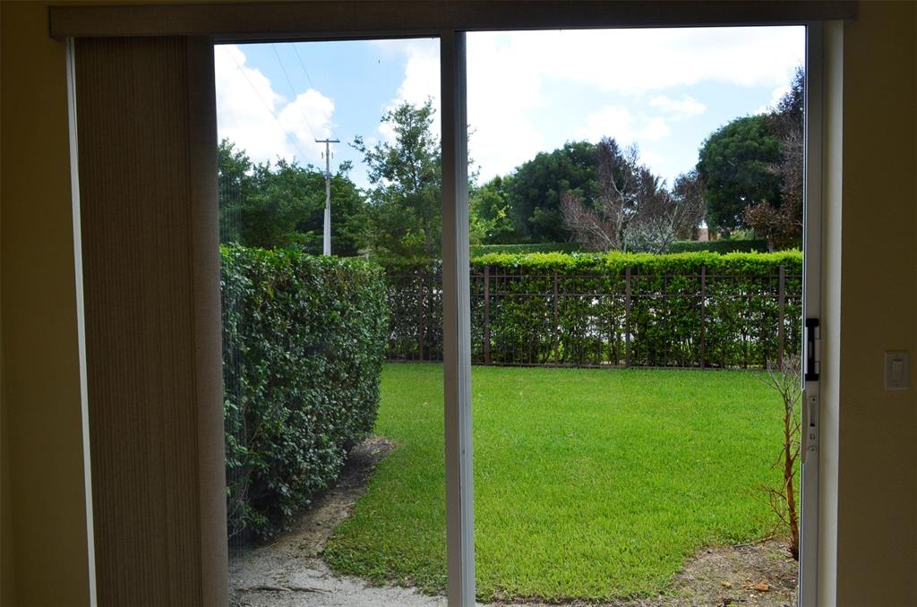 3210 Merrick Terrace, Unit 1503 Margate, FL 33063 - Photo 23 of 24 a view of a garden from a window