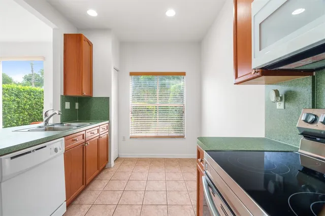 a kitchen with stainless steel appliances granite countertop a sink and a stove