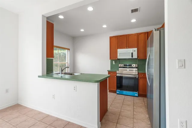 a kitchen with stainless steel appliances granite countertop a stove and a sink