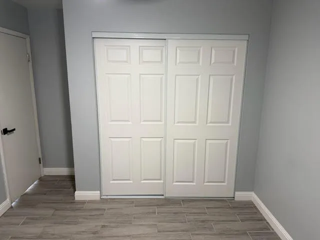 an empty room with wooden floor