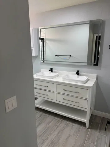 a bathroom with a sink and a mirror