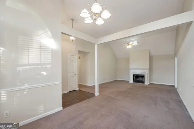 a view of an empty room with a fireplace