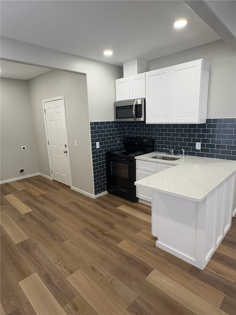 1518 Rochester Street Bryan, TX 77803 - Photo 11 of 23 a kitchen with granite countertop a stove and a sink