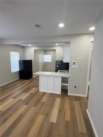 a large kitchen with a large counter top and stainless steel appliances