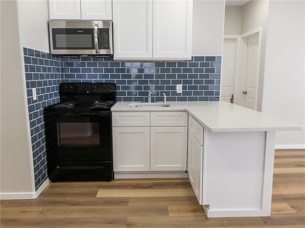 1518 Rochester Street Bryan, TX 77803 - Photo 3 of 23 a kitchen with a sink and a stove top oven