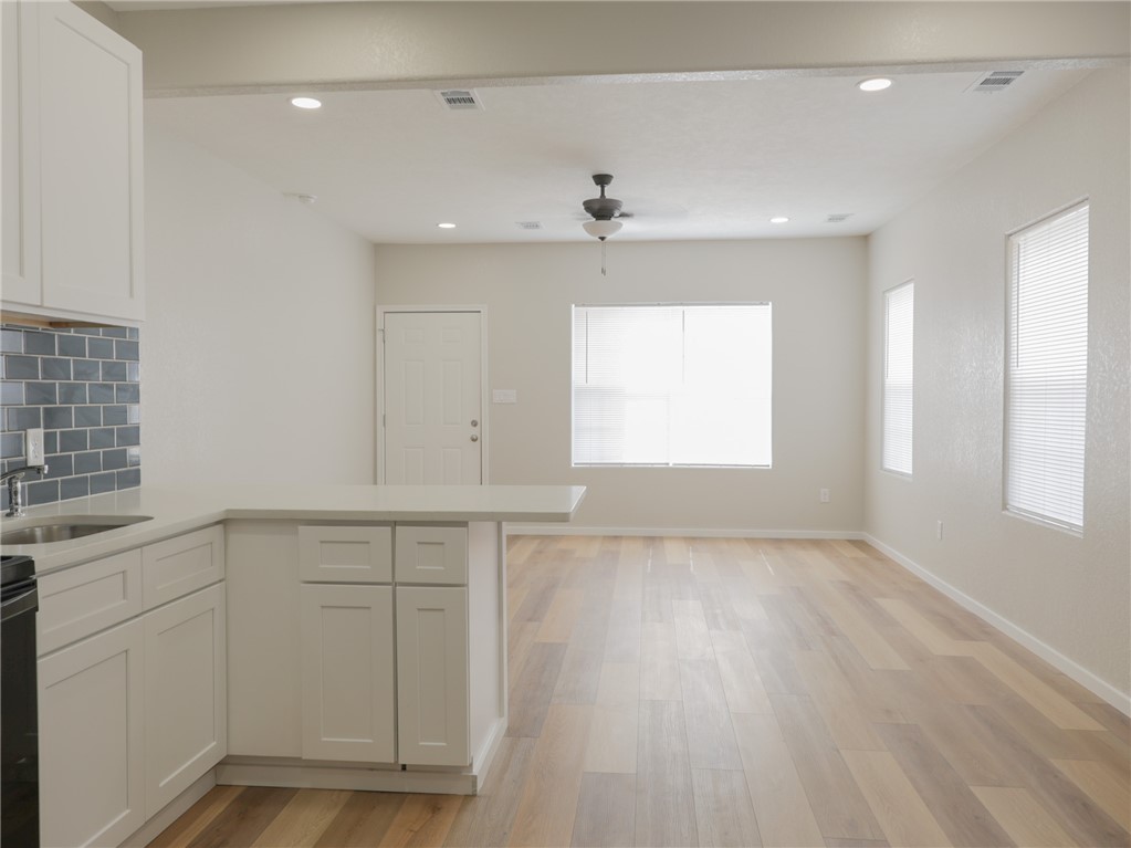 1518 Rochester Street Bryan, TX 77803 - Photo 4 of 23 a view of an empty room with a window and wooden floor