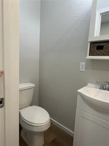 a white toilet sitting next to a bathroom sink
