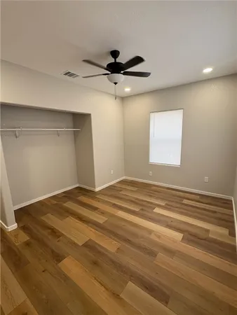 a view of a room with a ceiling fan