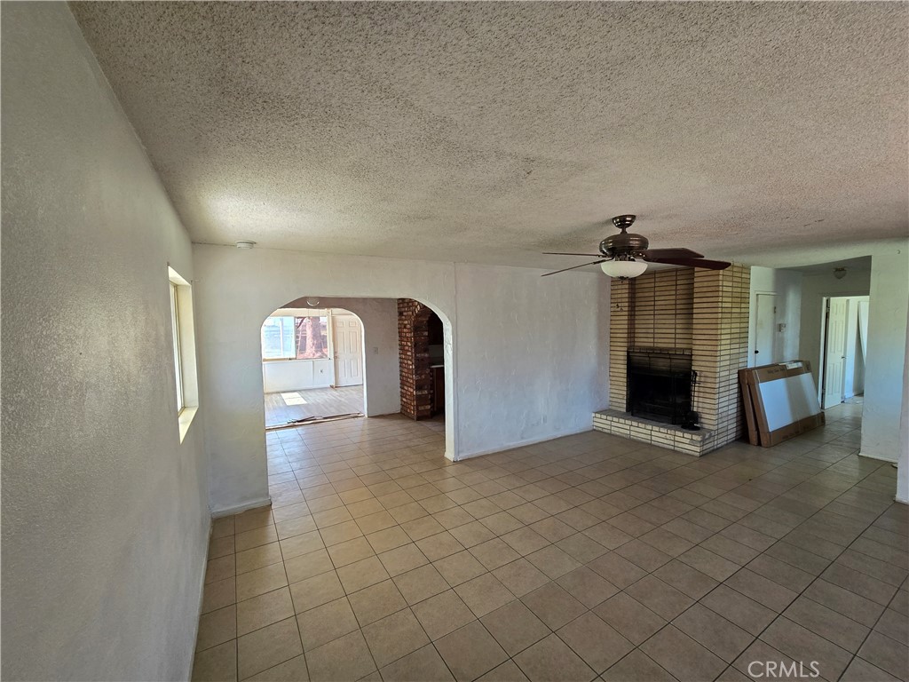 11067 Maureen Drive Cherry Valley, CA 92223 - Photo 11 of 23 a view of empty room with a fireplace