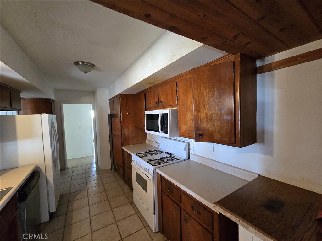 11067 Maureen Drive Cherry Valley, CA 92223 - Photo 14 of 23 a kitchen that has a sink and a stove top oven