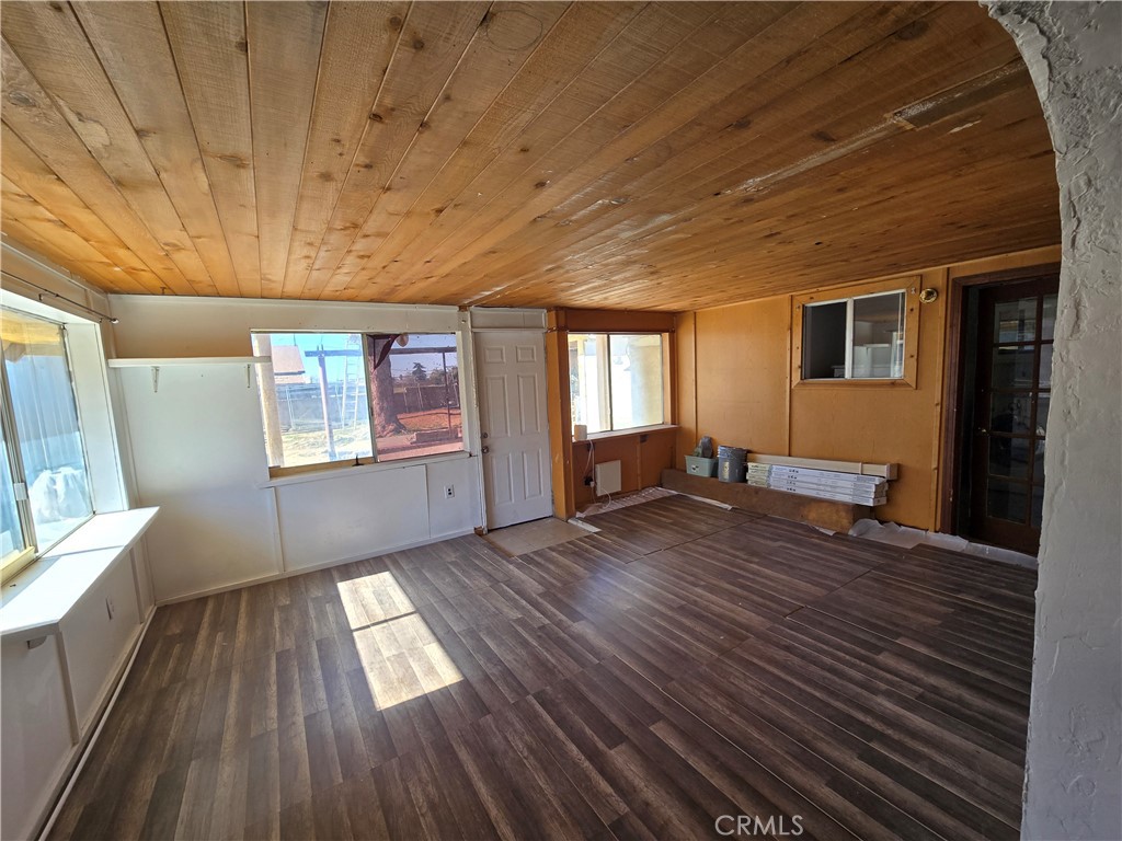 11067 Maureen Drive Cherry Valley, CA 92223 - Photo 15 of 23 a view of an empty room with wooden floor and a window