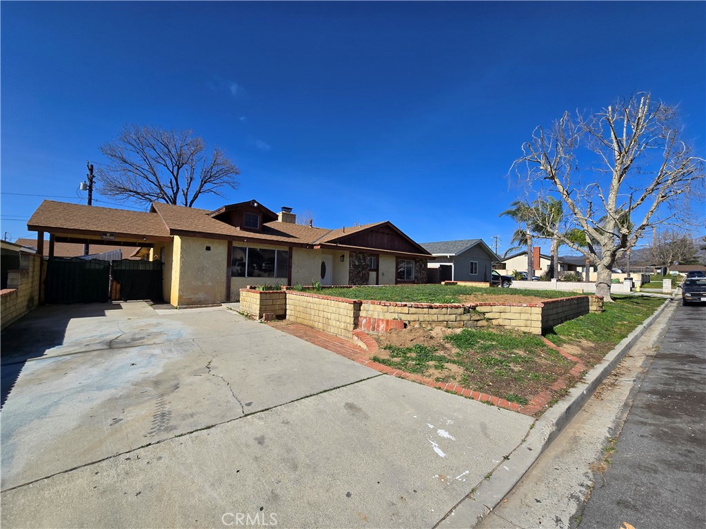 11067 Maureen Drive Cherry Valley, CA 92223 - Photo 5 of 23 a front view of a house with a yard