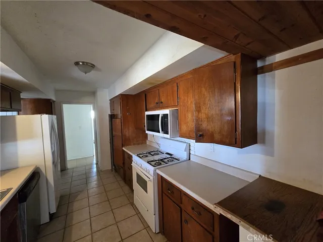 a kitchen that has a sink and a stove top oven