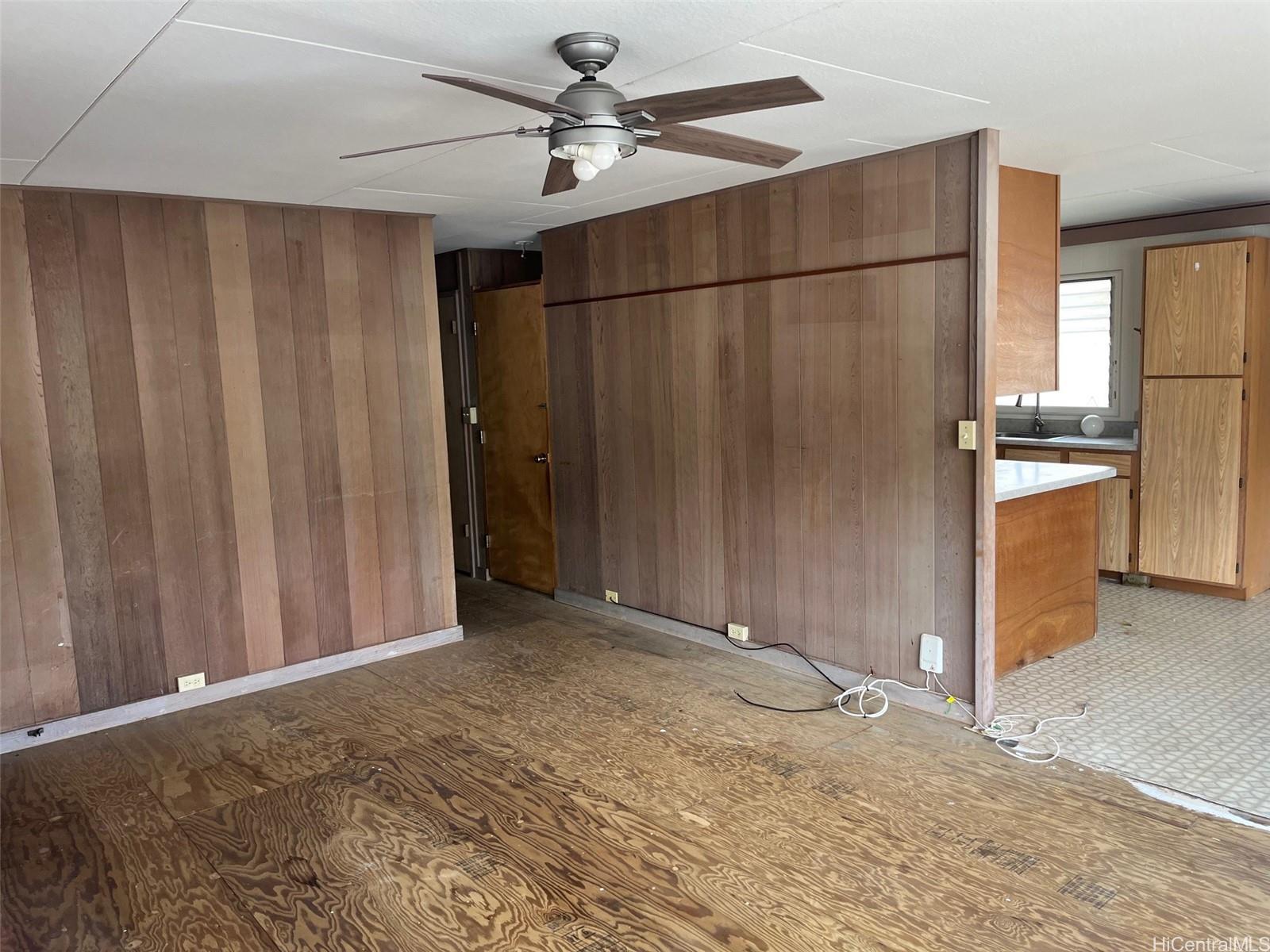 2153 Booth Road Honolulu, HI 96813 - Photo 13 of 18 a view of a livingroom with a chandelier fan and wooden floor