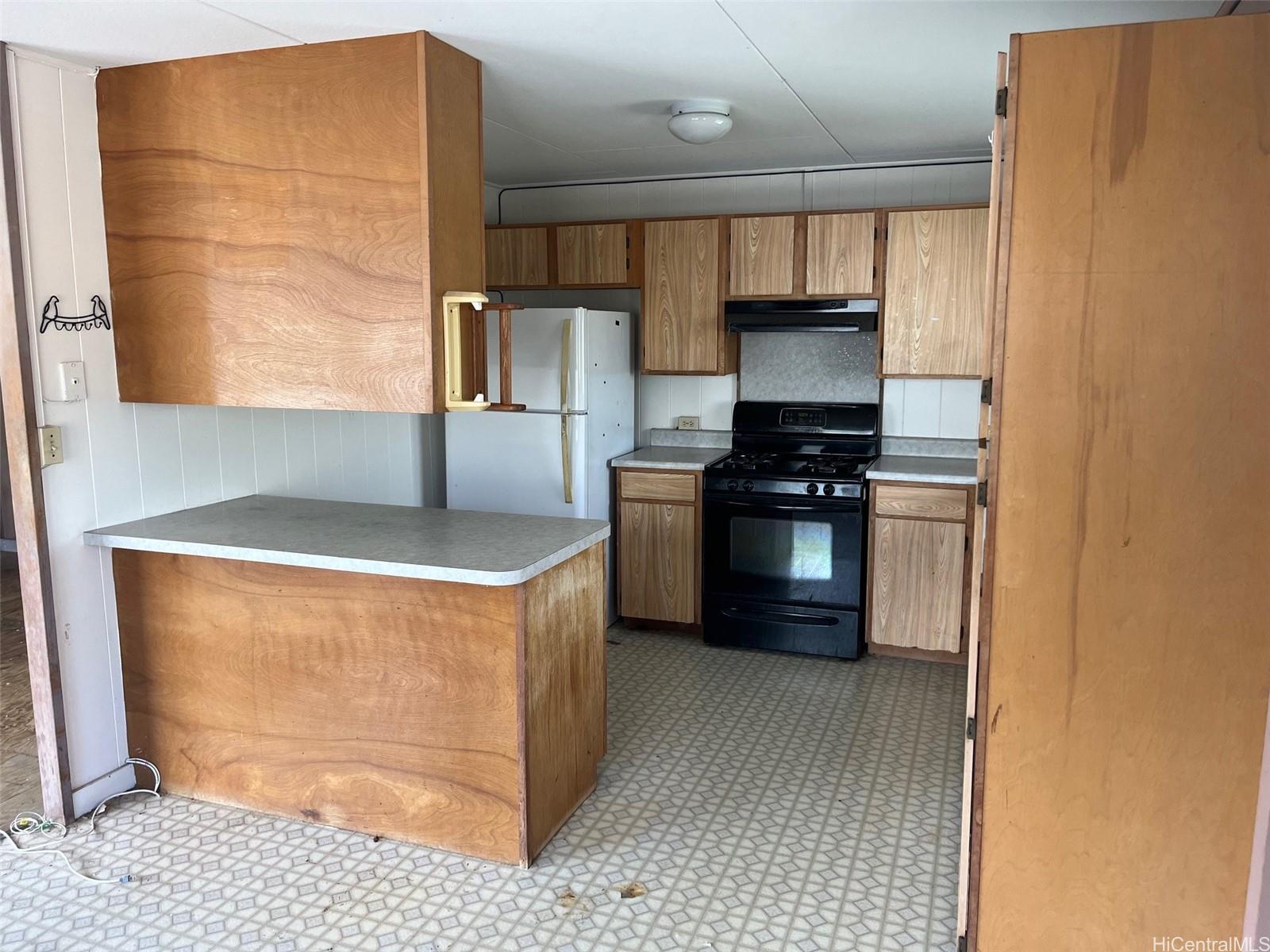 2153 Booth Road Honolulu, HI 96813 - Photo 14 of 18 a kitchen with stainless steel appliances granite countertop a stove a sink and a refrigerator