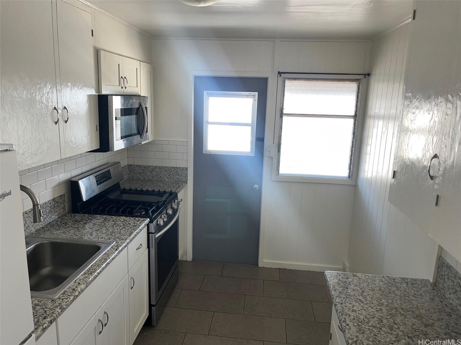 2153 Booth Road Honolulu, HI 96813 - Photo 4 of 18 a kitchen with stainless steel appliances granite countertop a sink stove and refrigerator
